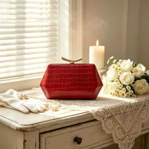 Elegant red crocodile texture hexagonal evening clutch bag on a vintage dresser