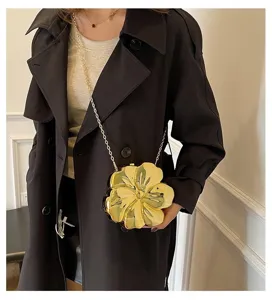 Luxury metallic gold flower acrylic evening bag with delicate chain strap on model