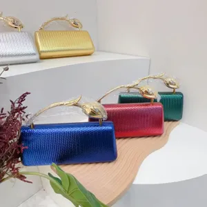 Detailed view of stylish metallic PU evening clutch bags with unique gold floral handles