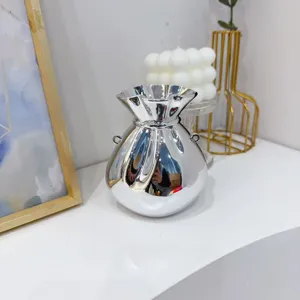 Elegant shiny silver metallic evening clutch bag in a unique money bag pouch shape