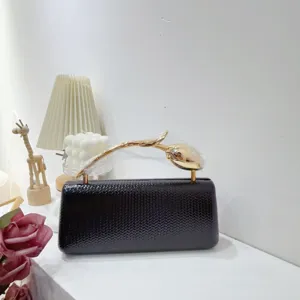 Elegant black PU leather evening clutch bag featuring a unique gold tulip flower handle detail