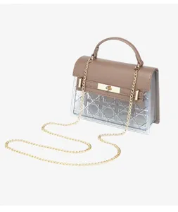 Detailed side view of women's vintage brown crossbody bag with gold chain strap