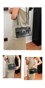 Stylish black crocodile embossed box crossbody bag with shiny gold tone zippers.