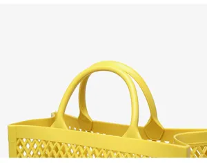 Close-up detail showing the handle and lattice design of a yellow PVC beach bag