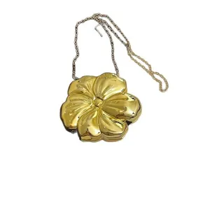 Elegant gold acrylic flower-shaped clutch bag with a metallic chain strap for women