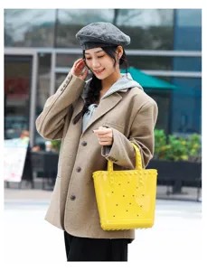 Stylish yellow PVC jelly beach bag with star cutouts carried by a model outdoors