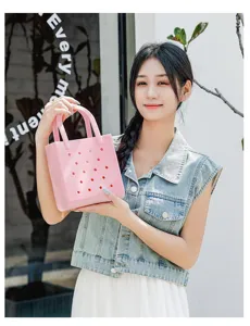 Asian model posing with a stylish pink waterproof PVC beach bag featuring hole pattern