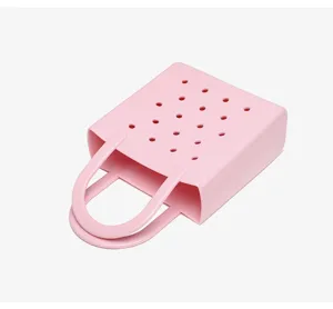 Detailed top-down view of a pink perforated PVC beach bag showing waterproof material.