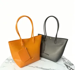 Close-up detail of minimalist TPU jelly tote bags in vibrant orange and dark grey colors