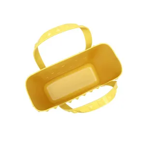 Stylish yellow perforated PVC beach tote bag featuring pyramid studded handles for summer