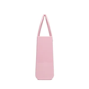Minimalist pink PVC waterproof beach tote bag with glossy finish shown from side view