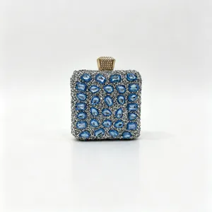 Luxurious silver evening clutch bag for women adorned with sparkling blue crystals.