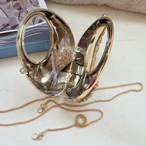 Detailed inside view of a luxury gold moon-shaped mini evening bag with rhinestones