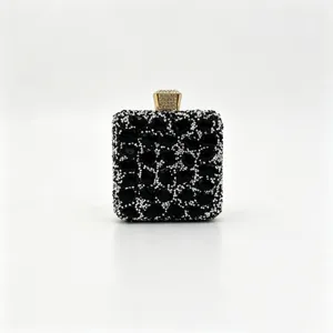 Detail view of luxurious black gemstone evening clutch with sparkling gold clasp