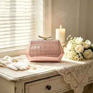 Detail of pink hexagonal crocodile pattern clutch bag in an elegant wedding scene setting