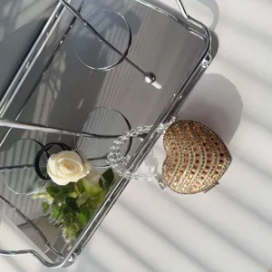 Close-up of heart-shaped mini lipstick bag with sparkling rhinestones and crystal chain.