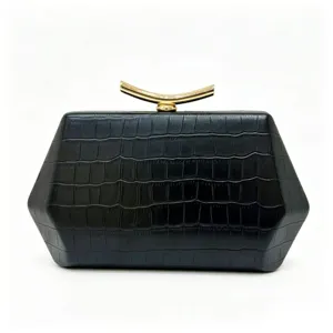 Close-up of a black hexagonal evening clutch bag with crocodile texture