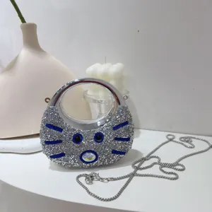 Elegant mini silver rhinestone evening bag with moon design and sleek metal chain strap