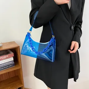 Detailed view of a stylish blue transparent PVC underarm bag featuring a chunky chain.