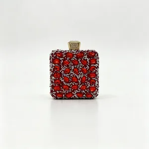 High-definition detail of a luxury red crystal-encrusted evening clutch with gold clasp