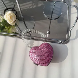 Detailed view of the sparkling pink rhinestone heart-shaped mini evening bag