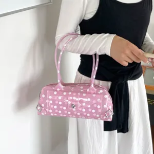 Detailed view of pink polka dot PVC jelly shoulder bag with stylish silver hardware