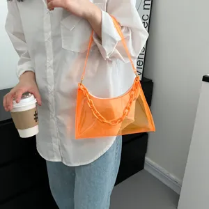 Trendy orange transparent PVC underarm bag featuring a chain strap shown on a model