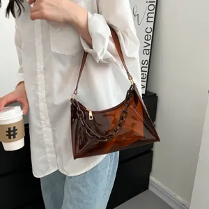 Detailed view of the brown transparent PVC underarm bag featuring a stylish chunky chain.