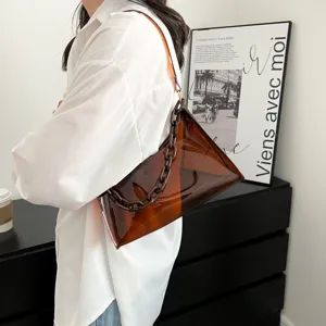 Minimalist brown PVC underarm jelly bag with decorative plastic chain strap on model