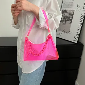 Detailed view of neon pink transparent PVC underarm bag with trendy plastic chain handle