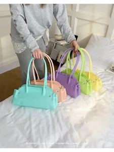 Multi-colored pastel PVC jelly baguette bags for women in a stylish bedroom setting