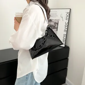 Side view of a glossy black PVC shoulder bag with a stylish chunky chain strap