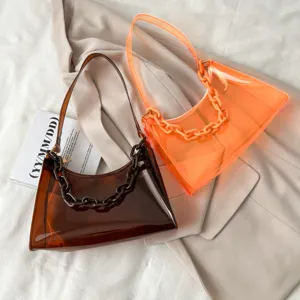 Detailed macro view of transparent PVC chain underarm bags in brown and orange.