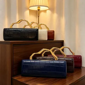 Detail view of retro crocodile pattern clutch bags with unique wavy gold handles