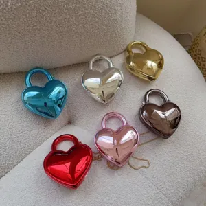 Close-up view of heart-shaped acrylic evening bags in multiple metallic finishes