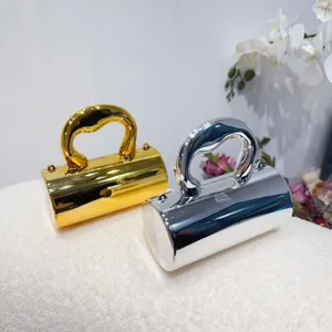 Macro view of metallic gold and silver mini acrylic evening bags on textured white surface