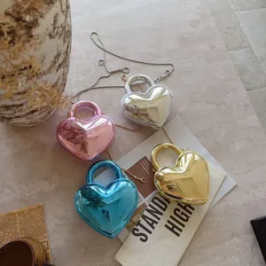 Luxury heart-shaped acrylic evening bags in metallic silver, gold, pink and blue.