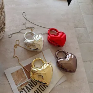 Chic heart-shaped acrylic evening bags in metallic silver, red, gold, and bronze.