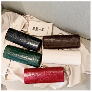 Detailed view of vintage crocodile pattern baguette clutch bags in five vibrant colors
