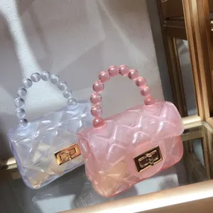Close-up of pink and clear quilted jelly bags with bead handles on a display shelf
