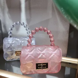Macro view of mini pink and clear quilted jelly bags with elegant bead handles.