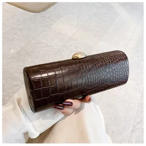 Detailed view of vintage dark brown crocodile pattern texture on long baguette clutch bag