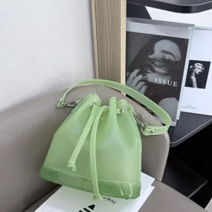 Detail showing the frosted TPU texture and drawstring closure of this green jelly bucket bag