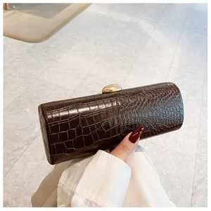 Retro brown crocodile embossed baguette clutch bag with elegant gold pebble clasp detail