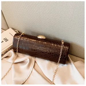 Detailed view of vintage brown croc-embossed baguette clutch with gold chain strap