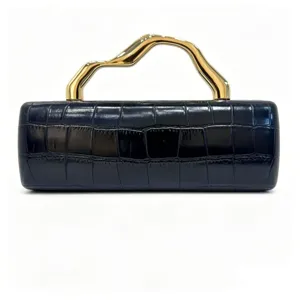Detailed view of elegant navy crocodile texture dinner clutch bag with wavy gold handle