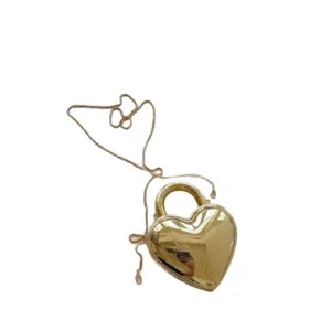 Stylish gold heart-shaped acrylic dinner bag with elegant chain strap and handle