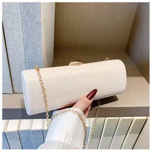 Detailed view of an elegant white crocodile pattern baguette clutch bag with a gold chain
