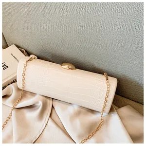 Elegant cream crocodile pattern baguette clutch bag with gold chain and clasp
