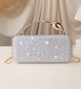 Luxury silver rhinestone evening clutch bag featuring an elegant golden rose metal handle